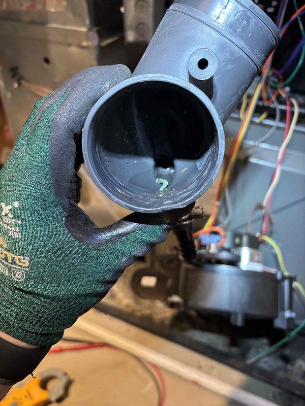 Responded to noise complaint regarding furnace making progressively louder motor sounds and temperature imbalance in one bedroom. Inspected PVC condensate drain system and identified blockage causing water backup. Cleared obstruction, verified proper drainage, and performed air handler tune-up to restore normal operation and balanced airflow.