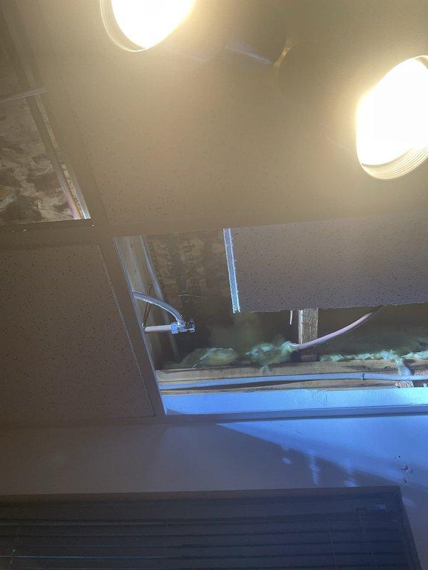 Responded to service request to convert copper fittings and pipes from old dishwasher to accommodate new dishwasher installation. Located and accessed hidden water shut-off valve through ceiling tiles. Successfully converted plumbing connections to compatible fittings for the new appliance, enabling third-party contractor to complete their installation.