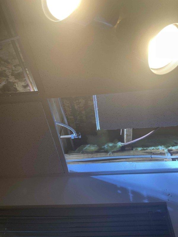 Responded to service request to convert copper fittings and pipes from old dishwasher to accommodate new dishwasher installation. Located and accessed hidden water shut-off valve through ceiling tiles. Successfully converted plumbing connections to compatible fittings for the new appliance, enabling third-party contractor to complete their installation.