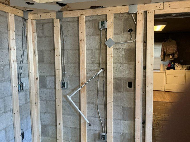 Completed electrical installation for kitchen remodel project, installing four new circuits and four recessed disc lights. Work involved running electrical conduit through existing concrete block walls with wood framing, mounting junction boxes at standard heights, and connecting all necessary wiring for the renovation.