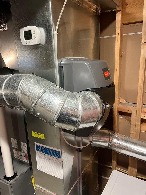 Completed annual tune-up on 8-year-old ICP furnace as part of Comfort Club membership. Inspected TempStar system components including connections, PVC venting, and ductwork, all functioning properly. Documented system condition with photos of the furnace installation and surrounding utility area.