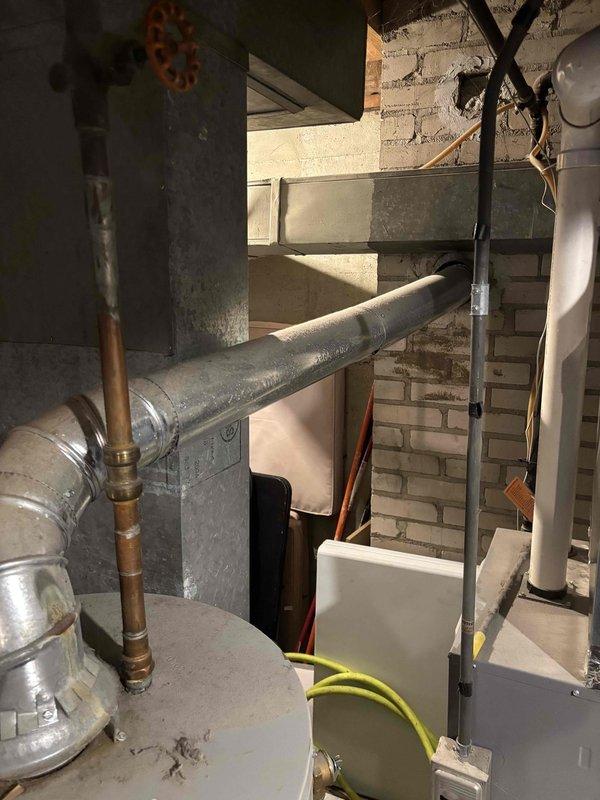 Inspected 14-year-old Bradford White water heater (2009 installation) due to customer complaint of shortened hot water availability during showers. Visual examination revealed aging unit with standard wear. Recommended replacement due to unit age and declining performance rather than repair, as efficiency and reliability will continue to deteriorate.