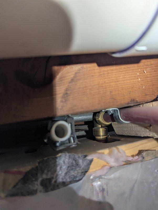 Replaced deteriorated connection lines on 2-year-old Navien boiler system. Work included removing damaged brass fittings and installing new copper-to-flex line connections secured through wooden joists. System was tested for proper operation and leaks after installation.