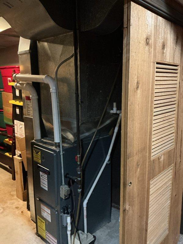 Conducted assessment for gas line installation project in a 1973 single-family home to convert electric appliances (kitchen, water heater, and laundry room) to natural gas. Existing furnace already utilizes natural gas supply. Documented current utility area configuration including furnace setup, ductwork, and available space for new gas line routing. Photos captured both the basement HVAC system and laundry area to determine optimal installation pathways for the proposed gas service expansion.
