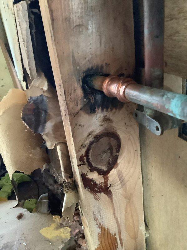 Completed repair of active leak where copper supply line penetrated wooden framing, which had caused significant water damage and wood deterioration. Replaced damaged kitchen faucet and installed new P-trap assembly to resolve drainage issues in the plumbing system. Provided consultation regarding potential gas line modifications as requested.