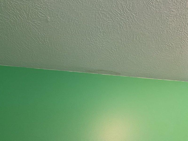 Inspected attic area where PVC pipe joint was found to be leaking through ceiling. Documented pre-existing water damage to textured ceiling below the leak point and surrounding drywall. Repaired compromised PVC pipe connection, ensuring proper seal and testing for continued leakage before completing service.