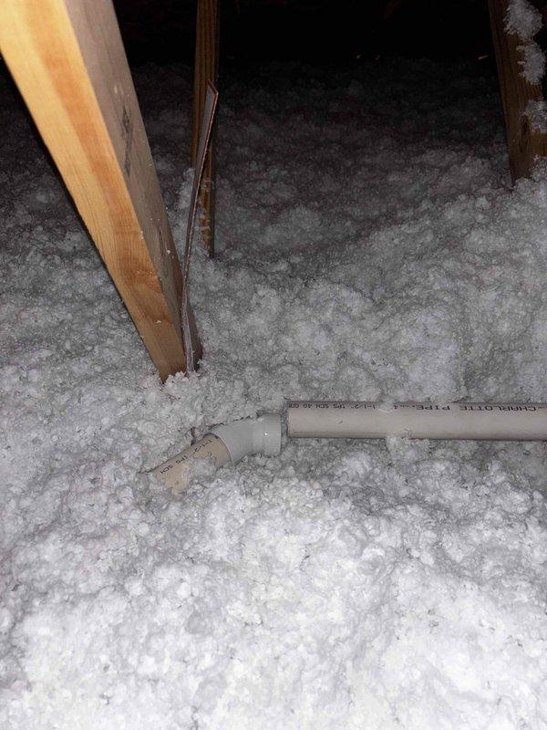 Inspected attic area where PVC pipe joint was found to be leaking through ceiling. Documented pre-existing water damage to textured ceiling below the leak point and surrounding drywall. Repaired compromised PVC pipe connection, ensuring proper seal and testing for continued leakage before completing service.