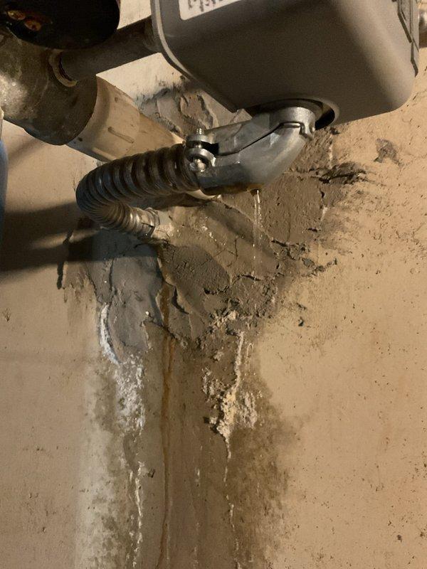 Identified water intrusion at foundation penetration point where well water line and electrical conduit enter basement. Observed significant wall deterioration with mineral deposits and staining. Confirmed leak stops when well pump is turned off and system pressure is released. Inspected pressure tank assembly and control components for potential repair options without excavation.