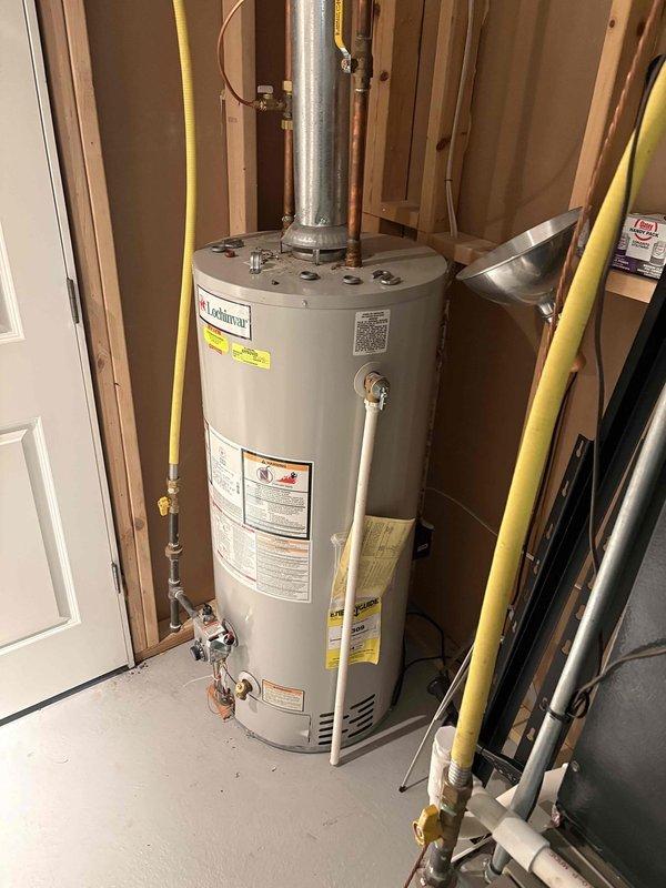 Completed diagnostic assessment of 16-year-old water heater with temperature regulation issues. Unit is still functional but showing age-related performance decline. Provided customer with replacement options and quote as requested, documenting current installation configuration with photos for proper sizing of potential replacement unit.