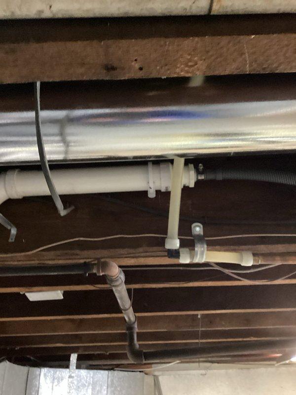 Successfully completed dishwasher drain installation by connecting new 13' PVC line to existing 2" drain system. Installed approximately 10' of new PEX water lines tied into existing 3/4" hot water supply with new local shutoff valve. Added ice maker supply line connected to existing 3/4" cold water line, with all connections properly secured to joists in unfinished ceiling area.