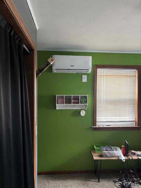 Completed installation of mini-split ductless system in two rooms of residence (main living area with green walls and child's Batman-themed bedroom). Units were properly wall-mounted and secured with all electrical connections verified for proper operation.