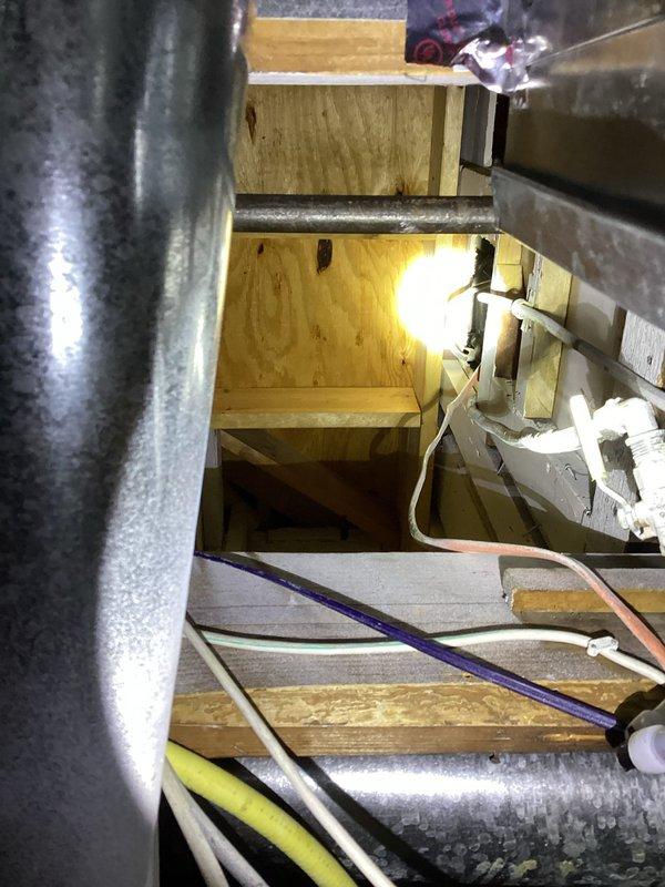 Conducted inspection of disconnected shower drain and assessed plumbing system for water pipe replacement estimate. Examination of confined mechanical space revealed existing galvanized metal ductwork, PVC pipes, and electrical wiring in cramped conditions. Documented current infrastructure configuration to develop comprehensive replacement plan for aging water pipes.