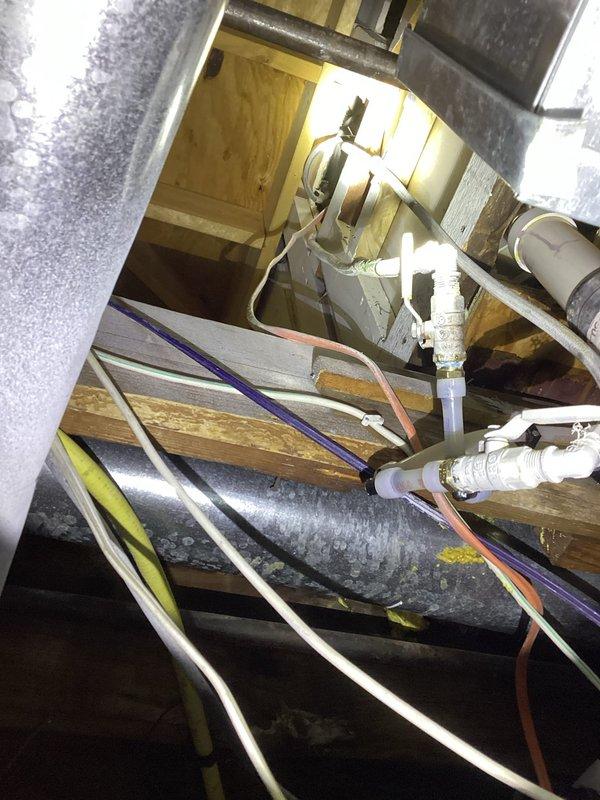 Conducted inspection of disconnected shower drain and assessed plumbing system for water pipe replacement estimate. Examination of confined mechanical space revealed existing galvanized metal ductwork, PVC pipes, and electrical wiring in cramped conditions. Documented current infrastructure configuration to develop comprehensive replacement plan for aging water pipes.
