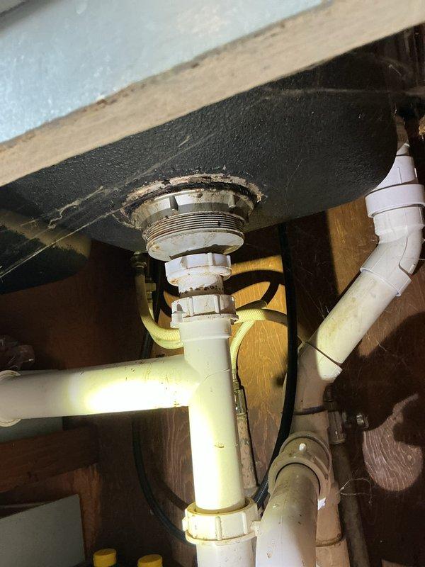 Responded to service call for multiple plumbing issues affecting one toilet and two sinks. Inspected and repaired corroded supply line connection at toilet with significant mineral buildup. Serviced kitchen and bathroom sink P-traps showing signs of age and deterioration, cleaning accumulated residue at drain connections to restore proper drainage function.