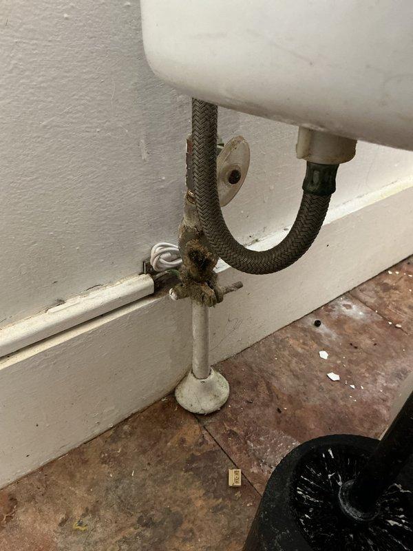 Responded to service call for multiple plumbing issues affecting one toilet and two sinks. Inspected and repaired corroded supply line connection at toilet with significant mineral buildup. Serviced kitchen and bathroom sink P-traps showing signs of age and deterioration, cleaning accumulated residue at drain connections to restore proper drainage function.