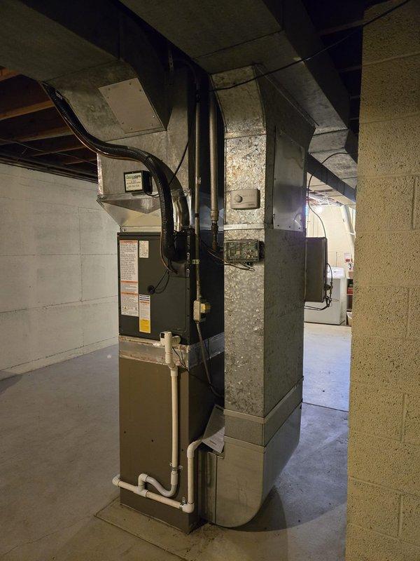 Successfully completed installation of Amana air conditioning system, including outdoor condensing unit mounted on concrete pad and new furnace with properly connected ductwork in utility area. System was fully tested and payment was collected upon completion.