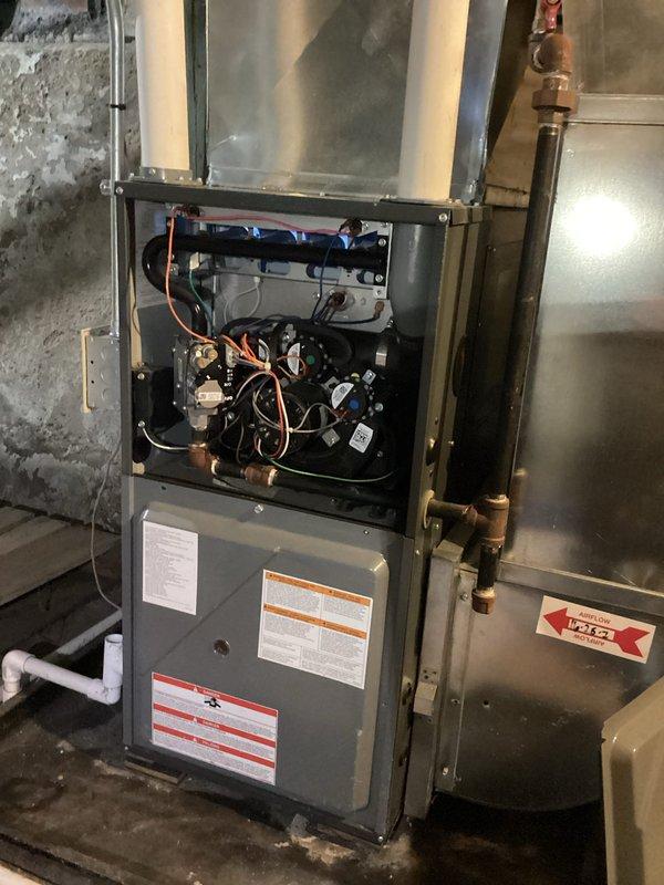 Performed annual heating maintenance on 8-year-old furnace. Inspected internal components including circuit board and wiring connections. Noted significant copper pipe corrosion with blue-green oxidation in the crawl space/basement area, suggesting possible water leakage or high humidity conditions that require attention.