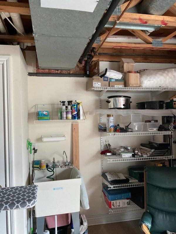 Completed site assessment for gas line installation to accommodate client's dryer. Inspection of the utility area revealed exposed ceiling structure with wooden joists and existing PVC plumbing lines. Documented current conditions with photos, including utility area layout and ceiling access points marked with construction indicators, to facilitate accurate project estimation.