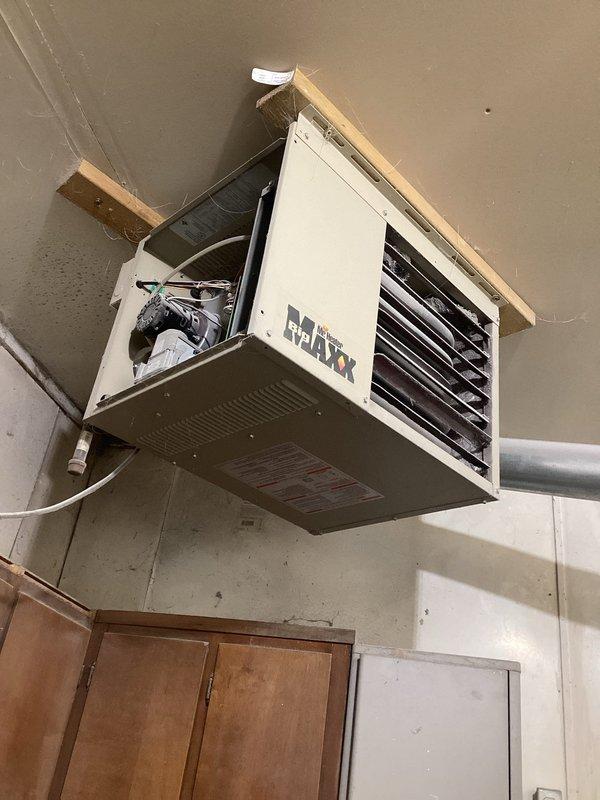 Diagnosed 30-year-old garage heater that failed shortly after recent electric board replacement. Inspection of the MAXX ceiling-mounted unit revealed electrical connection issues at the control panel that were preventing proper heating function. Repaired faulty wiring connections and verified system operation with successful heat cycle test.
