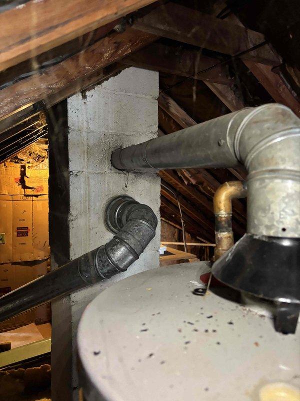 Responded to no-heat call for horizontal attic furnace approximately 20+ years old. Diagnosed ignition failure despite functioning blower. Inspection revealed significant heat exchanger deterioration and cracking, rendering unit unsafe for operation. System was red-tagged and customer advised of need for complete furnace replacement due to safety concerns.