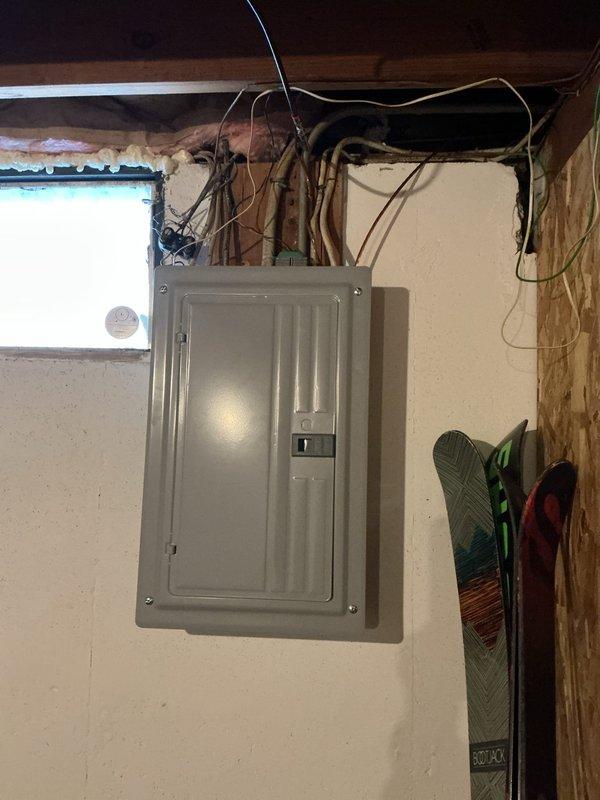 Conducted a service upgrade assessment for a 68-year-old residential property, focusing on the existing exterior electrical conduit work and main panel. Inspection revealed an aging meter installation with weathered conduit requiring replacement, and an indoor main breaker panel with multiple circuits and exposed wiring in the basement area. Provided customer with comprehensive upgrade options to bring electrical service to current code requirements.