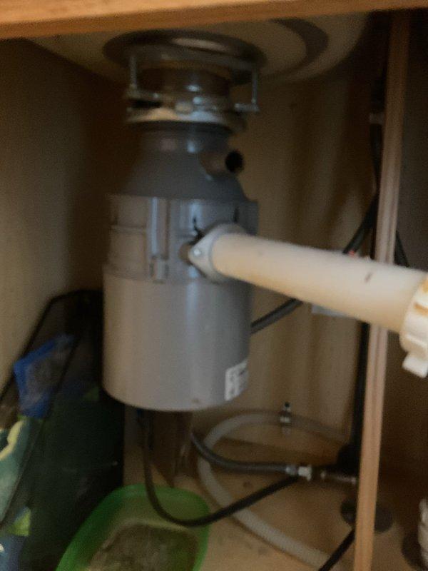 Responded to service call for non-operational garbage disposal with reported burning odor and potential leak. Inspected the unit, which was previously supplied by customer's home warranty company but never installed. Completed installation of the new disposal unit under the kitchen sink, securing all connections and verifying proper electrical functionality. Also identified and repaired minor leak in the plumbing connection beneath the sink.