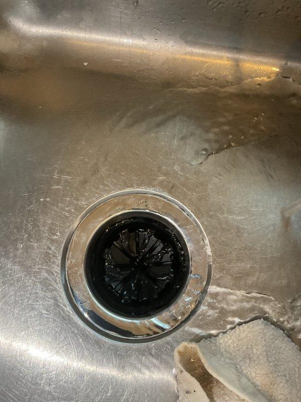 Responded to service call for non-operational garbage disposal with reported burning odor and potential leak. Inspected the unit, which was previously supplied by customer's home warranty company but never installed. Completed installation of the new disposal unit under the kitchen sink, securing all connections and verifying proper electrical functionality. Also identified and repaired minor leak in the plumbing connection beneath the sink.