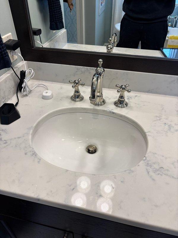 Successfully completed quoted repair involving disconnection of hot side handle assembly and installation of new hot end valve assembly while preserving the existing chrome faucet trim. Verified proper functionality of the newly installed components and confirmed no leaks in the plumbing system beneath the undermount sink.