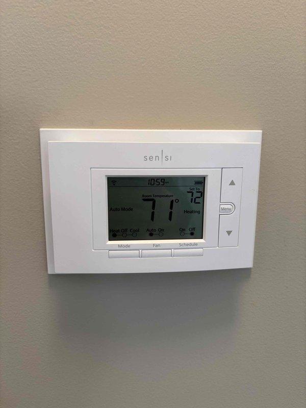 Completed annual maintenance on EnergiAir WT 11-2031 furnace and humidifier. Removed and inspected Emerson 1F87U-42WF thermostat, verifying proper connections and battery condition. Confirmed system operation with the Sensi digital thermostat showing proper temperature control (71°F room/72°F set) in heating mode.
