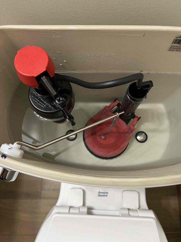 Performed diagnostic assessment on American Standard toilet installed in December that has required multiple service calls. Inspected internal tank components including flapper valve, fill valve, and flush mechanism. Documented ongoing issues with photographs for possible warranty replacement consideration.