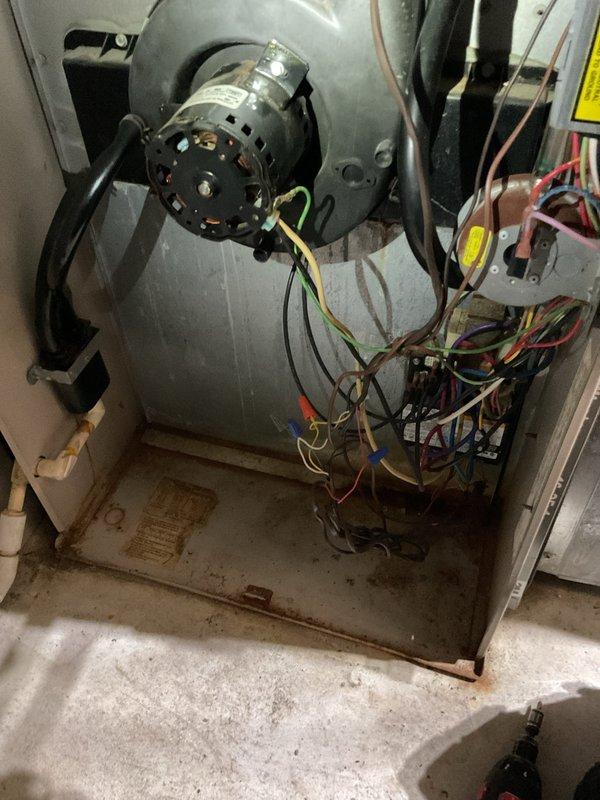 Responded to no-heat call for 25-year-old furnace. Upon inspection, found the blower motor was operational but showing significant age-related wear with discoloration on components. Cleaned accessible components and verified proper electrical connections to restore heating function.