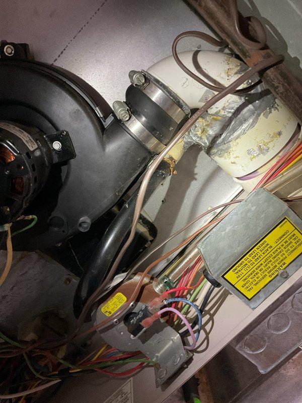 Responded to no-heat call for 25-year-old furnace. Upon inspection, found the blower motor was operational but showing significant age-related wear with discoloration on components. Cleaned accessible components and verified proper electrical connections to restore heating function.