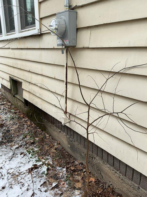 Conducted site visit to assess electrical service installation. Inspected exterior electrical meter (reading 03732) mounted on vinyl siding with proper conduit connections. Documented current meter configuration and surrounding area conditions for quote preparation.
