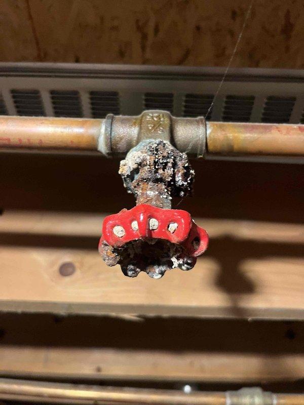 Responded to radiator leak in 20-year-old boiler system. Inspection revealed severe corrosion at copper pipe connection point with compromised integrity. Pressure gauge reading was abnormally low, indicating system pressure issues contributing to the leak. Replaced damaged pipe section and installed new connection fitting to restore proper system operation.