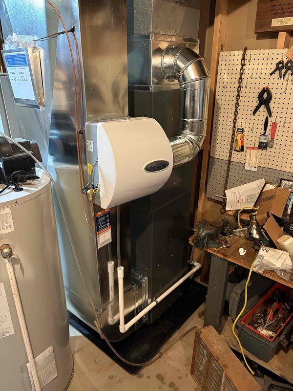 Completed installation of new Everest air conditioning unit mounted on concrete pad in exterior alcove, along with furnace system in utility room. New HVAC system includes complete ductwork connections, humidifier attachment, and all necessary electrical and refrigerant line connections. Payment collected upon completion of installation.