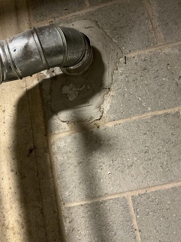 Conducted a comprehensive water heater replacement estimate at a 50+ year old residential property, examining the existing ventilation system which showed signs of deterioration and moisture damage at the connection point with the concrete block wall. Also provided consultation on drinking water filtration system options per customer's request.