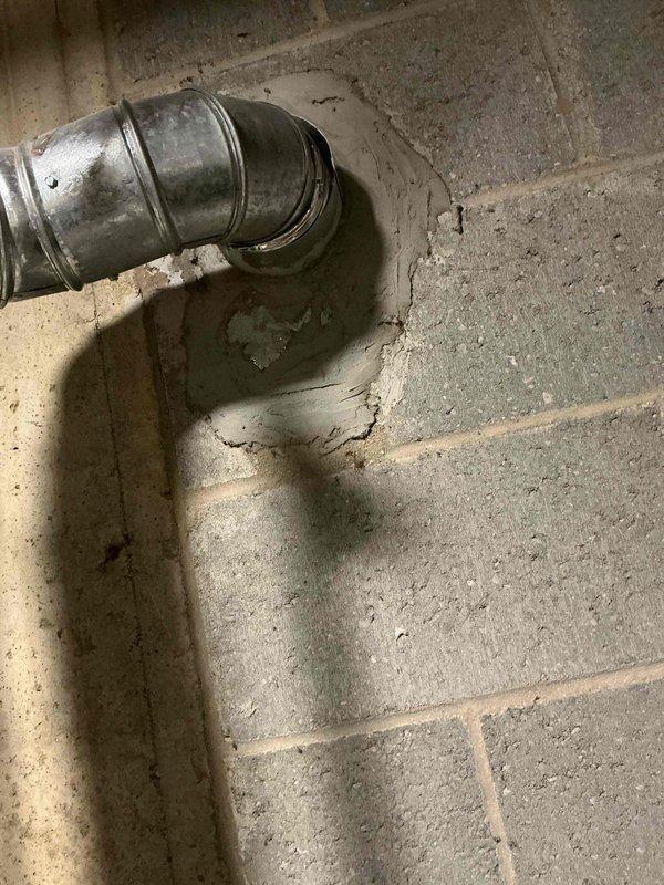 Conducted a comprehensive water heater replacement estimate at a 50+ year old residential property, examining the existing ventilation system which showed signs of deterioration and moisture damage at the connection point with the concrete block wall. Also provided consultation on drinking water filtration system options per customer's request.