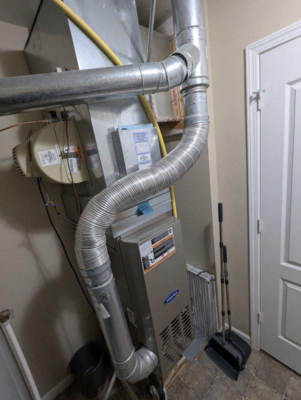 Responded to service call for leaking humidifier on 16-year-old Carrier system. Inspected installation and found water leaking from compromised seals in the cylindrical humidifier housing mounted to the ductwork. Replaced damaged seals and verified proper operation with no further leakage.