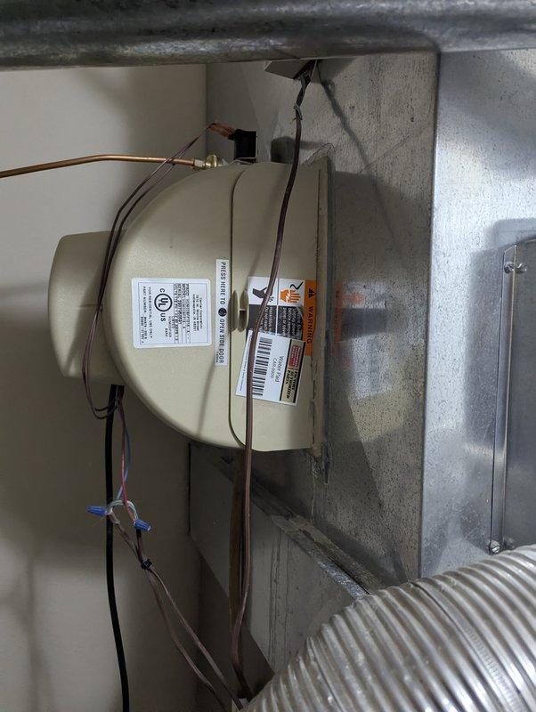 Responded to service call for leaking humidifier on 16-year-old Carrier system. Inspected installation and found water leaking from compromised seals in the cylindrical humidifier housing mounted to the ductwork. Replaced damaged seals and verified proper operation with no further leakage.