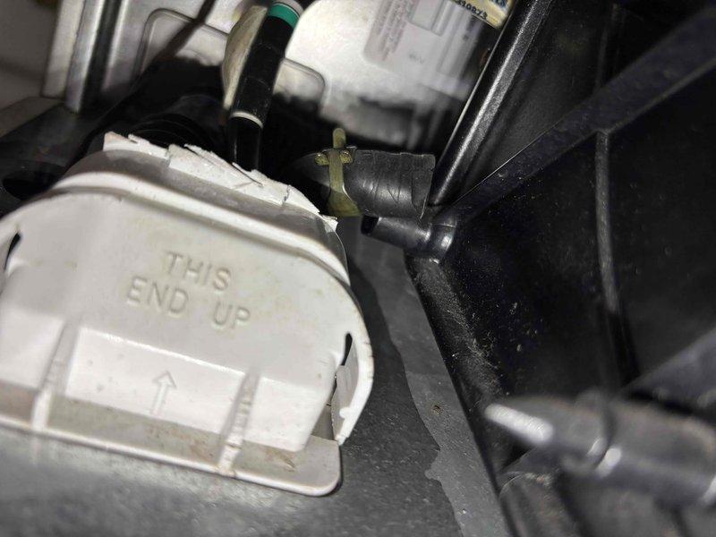Responded to water leak issue on 17-year-old CAR furnace. Discovered condensate drain tube misalignment with collection pan, causing water to leak underneath unit. Repositioned drain tube according to "THIS END UP" directional indicators and verified proper drainage path through the black corrugated discharge hose with green connector ring. System now operating correctly with no further leakage.