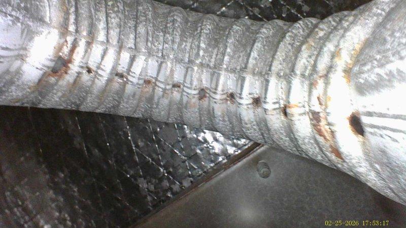 Responded to customer report of burning smell from furnace vent. Upon inspection, discovered significant rust and corrosion on flexible metal ductwork, particularly along the corrugated sections. Determined that accumulated dust and debris on corroded areas were causing the burning odor when heated. Performed thorough cleaning of affected ducts and completed preventative maintenance tune-up to restore proper system operation.