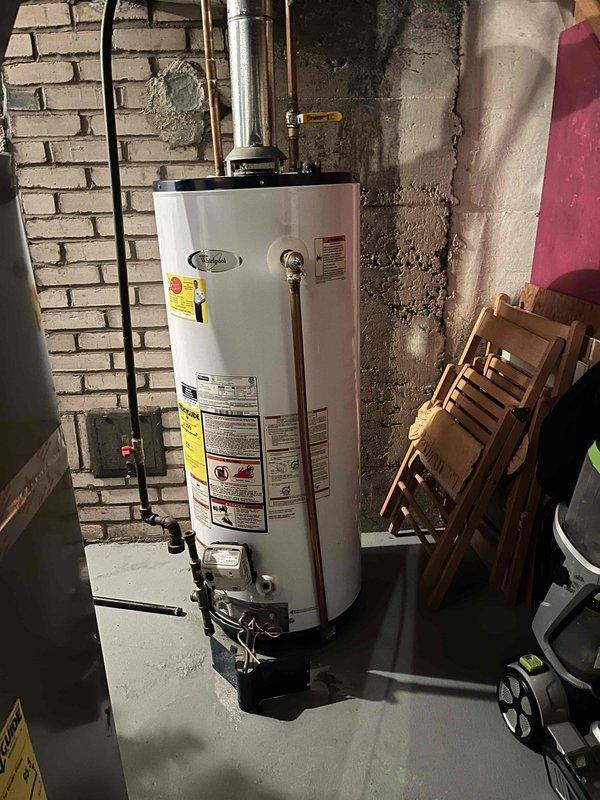 Replaced failed temperature sensor on 10-year-old Whirlpool water heater that was preventing hot water production. System now functioning properly with restored hot water supply.