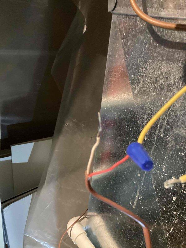 Responded to service call for 16-year-old Aprilaire humidifier that was not functioning. Inspection revealed significant mineral buildup on internal components and deteriorated wiring connections. Performed thorough cleaning of feed tube and water panel, replaced damaged wire connections with proper wire nuts, and restored system to normal operation.