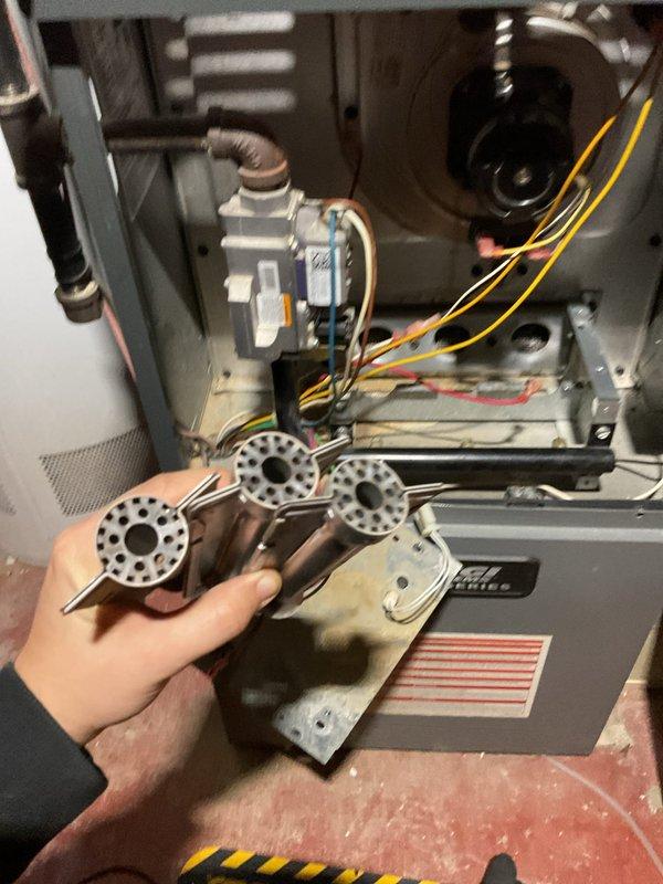 Responded to no heat call for 8-year-old ENE WT furnace with flame sensor error code causing lockout. Removed burner assembly to access and clean flame sensor with emery cloth, then reinstalled components and verified proper ignition sequence. Unit now operating normally with strong flame signal and no fault codes.