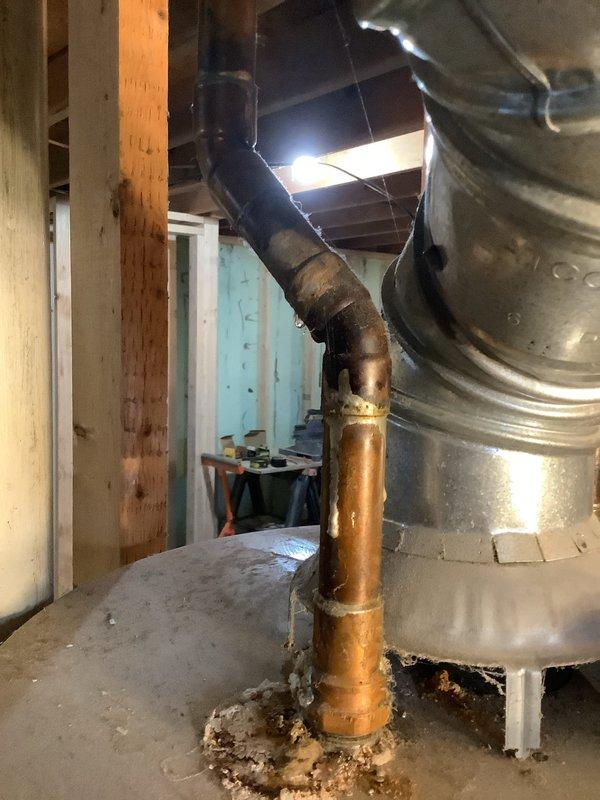Performed annual tune-up on 18-year-old Amana furnace with last maintenance in 2022. Inspection revealed significant copper pipe corrosion and mineral buildup at connection points to the flue system in the basement mechanical area. Documented issues with photos for customer reference.