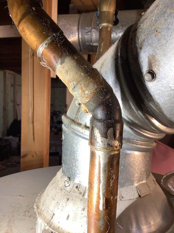 Performed annual tune-up on 18-year-old Amana furnace with last maintenance in 2022. Inspection revealed significant copper pipe corrosion and mineral buildup at connection points to the flue system in the basement mechanical area. Documented issues with photos for customer reference.