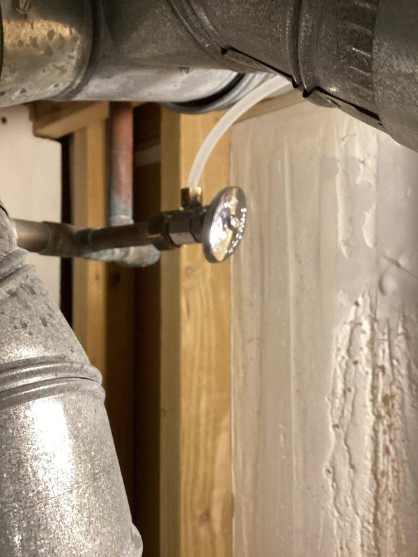 Diagnosed and repaired humidifier system in residence with low humidity issues. Identified water supply leak at connection point causing wall moisture damage and insufficient humidification. Replaced damaged valve fitting and restored proper water flow to unit, ensuring optimal humidity levels for the 22-year-old system.