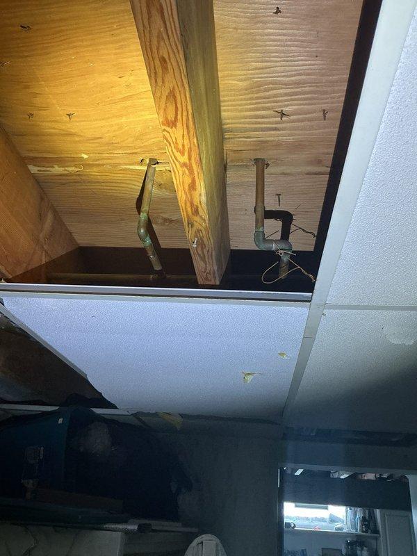 Installed new shut-off valves for sink faucet that was previously lacking isolation capability. Accessed plumbing through ceiling access panel to complete connection to main supply lines. Verified proper operation with no leaks at new valve connections.