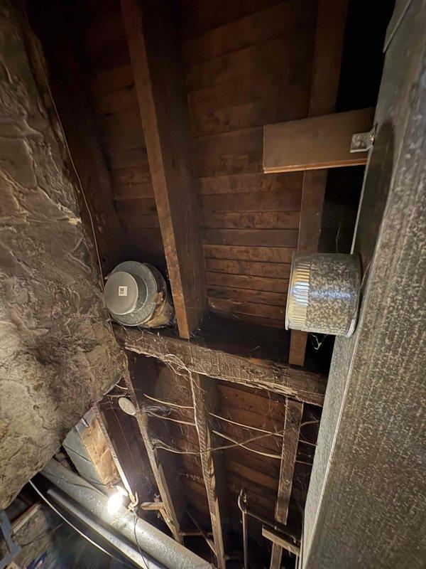 Inspected 16-year-old furnace system in lower unit of duplex home that was only heating to 65°F despite owner's replacement of capacitor, thermostat, high limit switch, and filter. Examination of attic ductwork revealed significant air leakage at connections. Sealed duct joints and recalibrated system, restoring proper heating function to desired temperature.