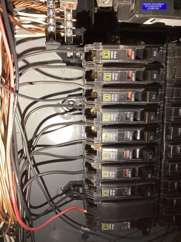 Performed Electrical Club Inspection of residential panel and exterior service connection. Inspected Square D breaker panel containing multiple 15A and 20A circuits with appropriate wiring and ground connections. Examined exterior service entrance, conduit, and junction box mounted on vinyl siding adjacent to HVAC equipment, confirming proper installation despite winter conditions.